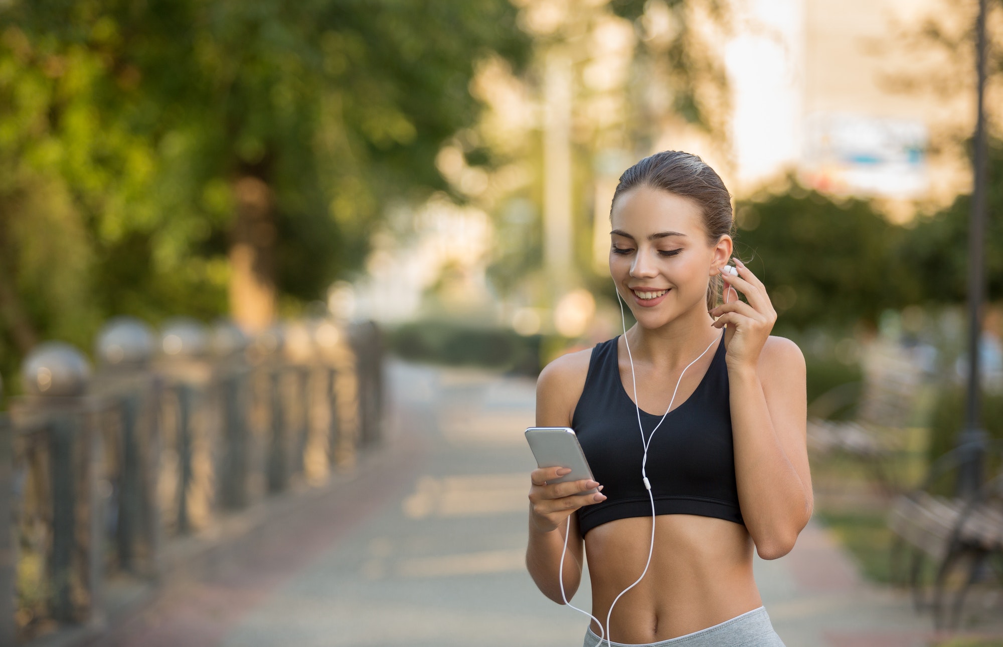 Girl choose music for running on smartphone