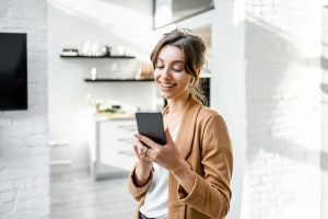 Business woman with smart phone at home