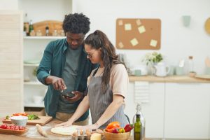 Couple cooking with mobile app