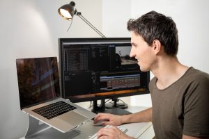 professional video editor on his desk editing an online video