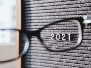 Letter board - 2021 through eyeglasses. 2021 goals. Politic, social, economical results of 2021.
